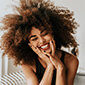 happily smiling girl with curly hairs